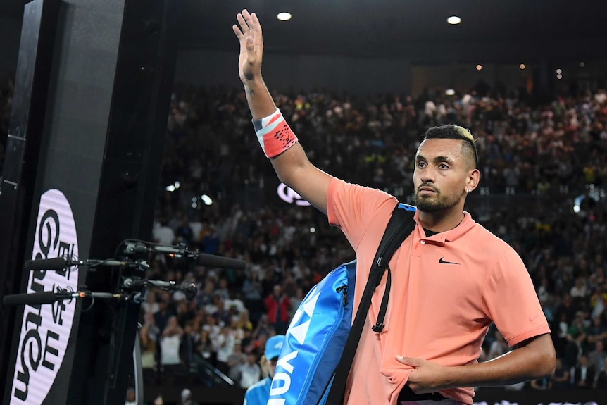 Nick Kyrgios waves as he leaves Rod Laver Arena after losing to