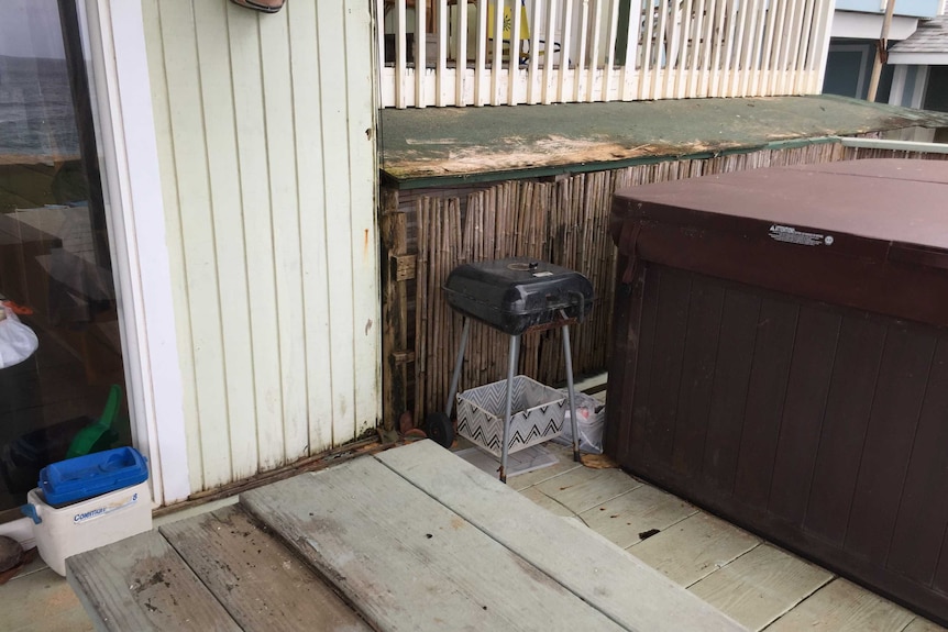 A rotting wood area with a dirty deck.