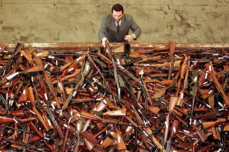 A man sorts through hundreds of guns 