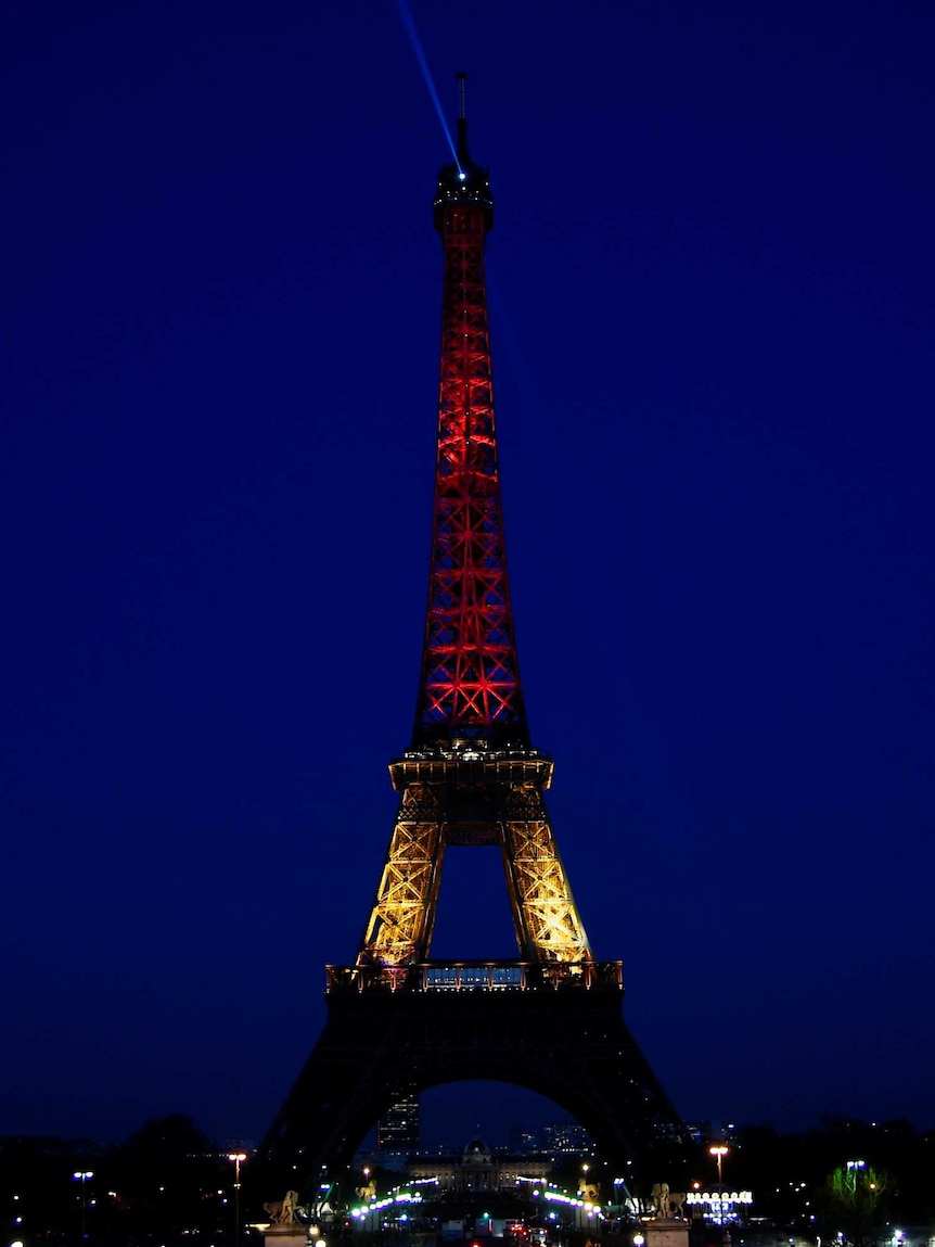The Eiffel Tower illuminated in yellow and red after the Brussels attacks.