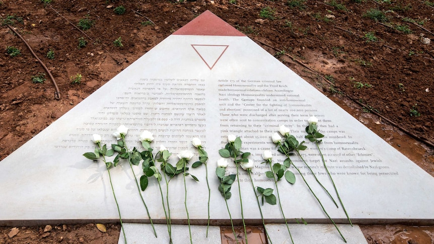 Flowers lay on a memorial to thousands of gay Holocaust victims.