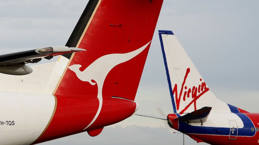 Qantas and Virgin Blue planes pass each other.