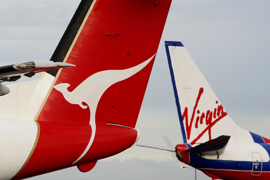 Qantas and Virgin Blue planes pass each other.