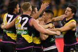 Tigers players react after Dion Prestia (4th L) kicks a goal against Hawthorn at the MCG.
