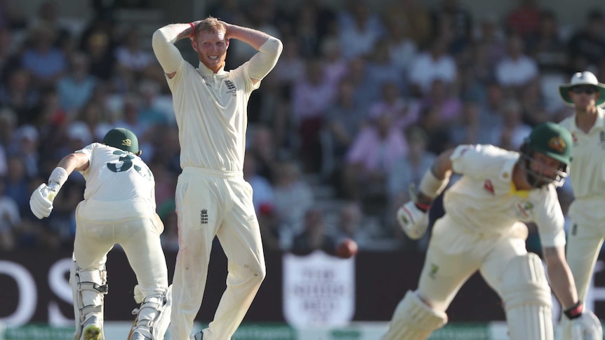 England bowler Ben Stokes puts his hands on his head as Marnus Labuschagne and Matthew Wade score runs during an Ashes Test.
