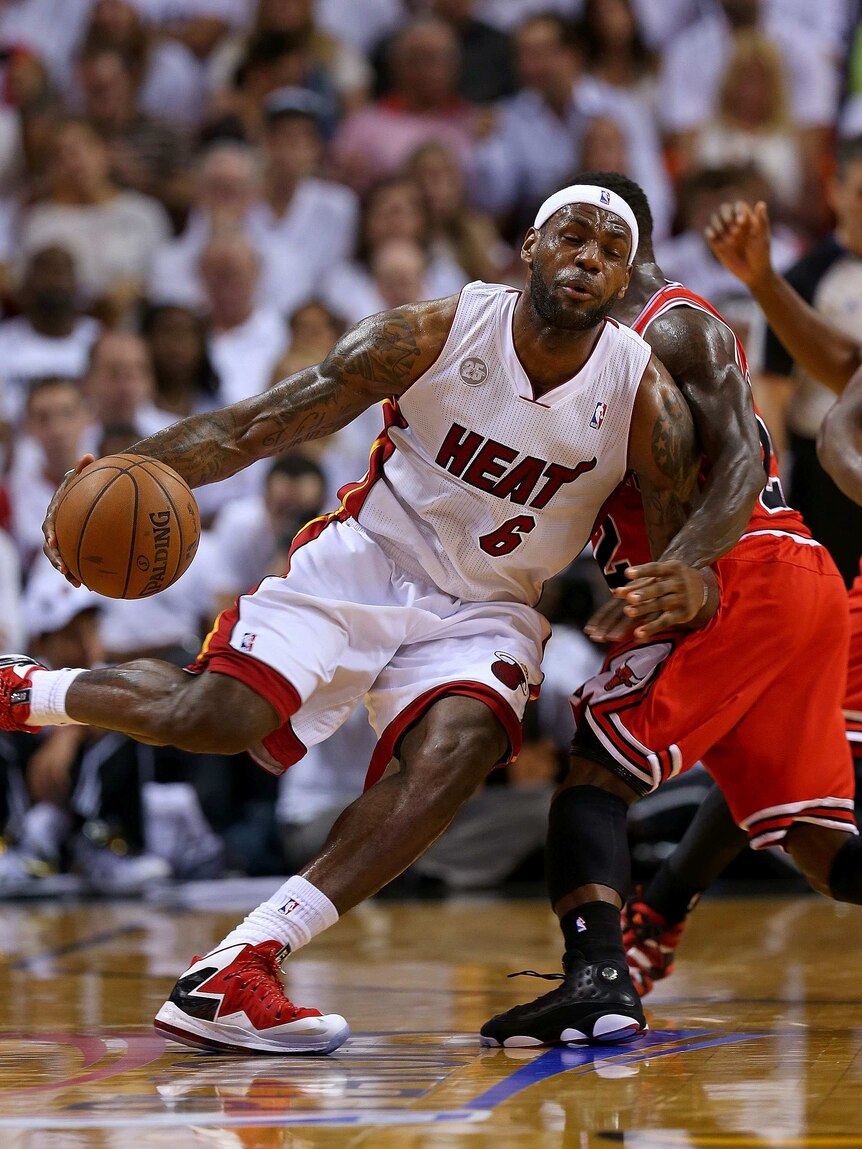 Offensive pressure ... LeBron James tries to beat the defence of Nate Robinson