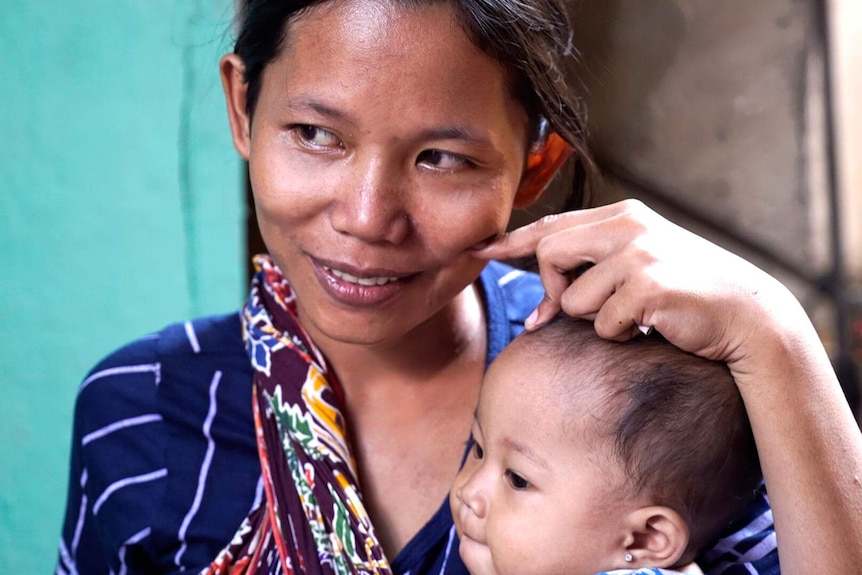 Jakarta resident Devi Mariani with her child