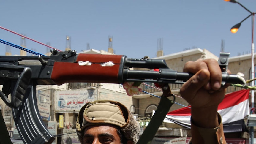 A Yemeni soldier joins anti-government protestors after switching allegiance to the opposition