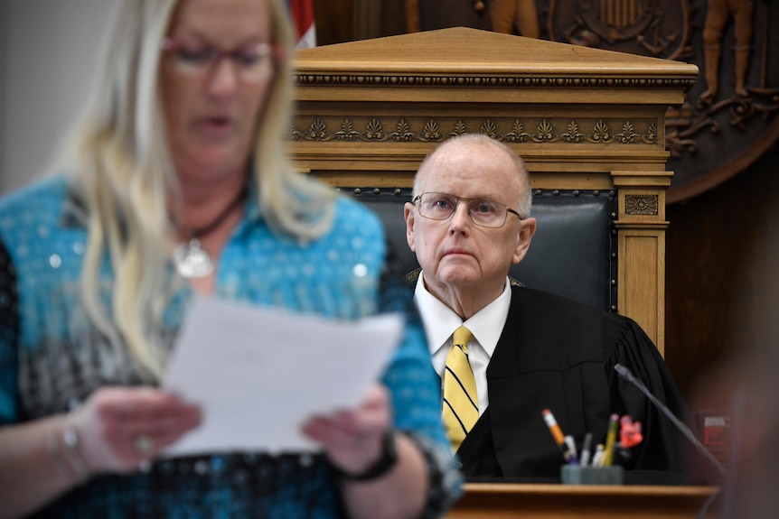 Judge Bruce Schroeder listens as a woman reads the verdict.