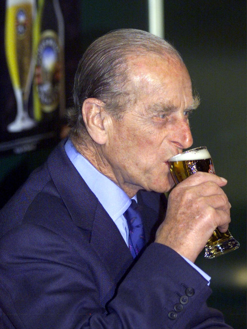Britain's Prince Philip, the Duke of Edinburgh, sips from a glass of Boags beer