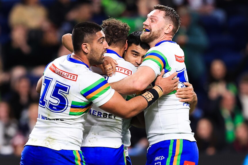 Canberra Raiders celebrate by hugging