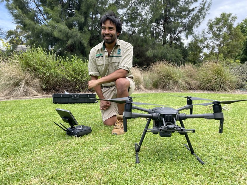 Sakib Kazi kneeling next to a drone.