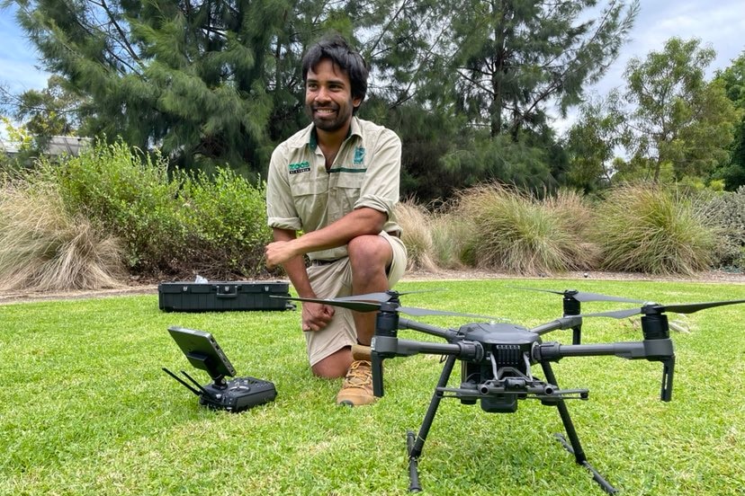 Sakib Kazi kneeling next to a drone.