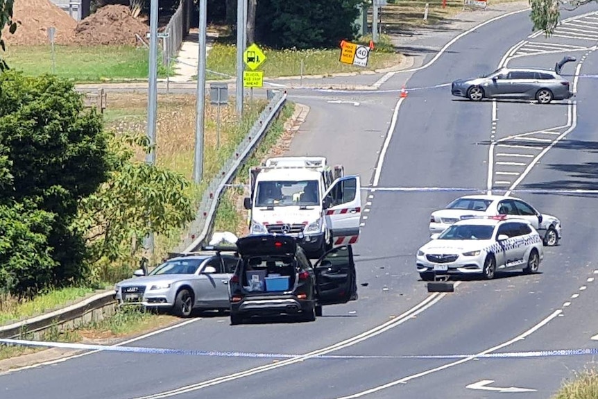 A number of cars at the side of a road in Drouin where a man was shot.