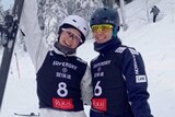 Danielle Scott and Laura Peel smile and stand next to each other in the snow