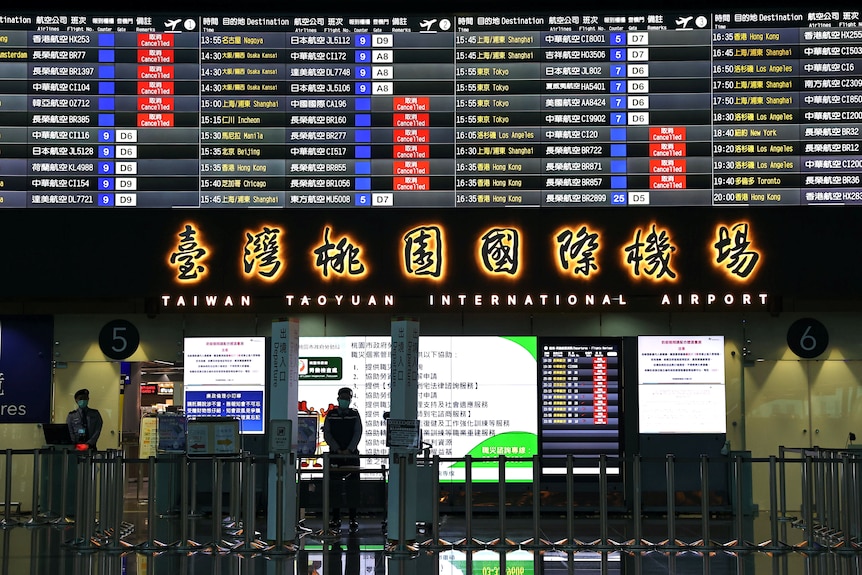 An airport terminal  showing signage in Taiwanese script.
