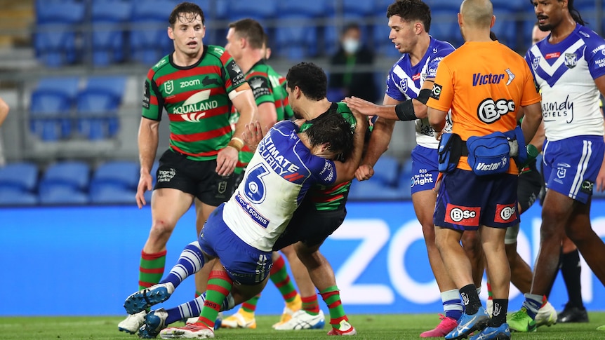 A Canterbury NRL player tackles a South Sydney opponent after the whistle.