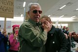 An Iranian green card holder cries on the shoulders of her father after being released at Dallas airport