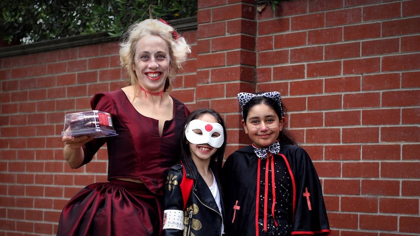 A woman and two children dressed up for Halloween
