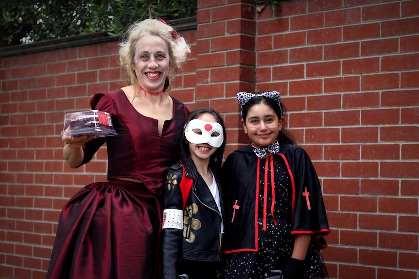 A woman and two children dressed up for Halloween