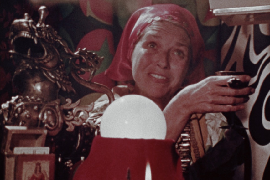 Film still of a fortune teller with a crystal ball in The Amusement Park