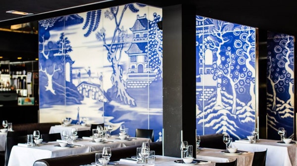 a posh restaurant with blue porcelain looking walls