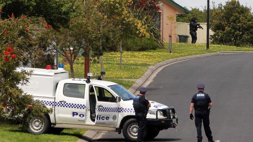 Heavily armed police officers search Trevorrow Street at Mount Gambier