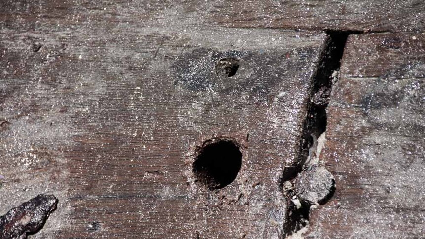 Old wood showing holes for pegging