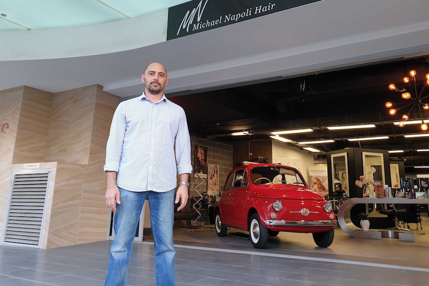 Michael Napoli stands out the front of his hair salon.