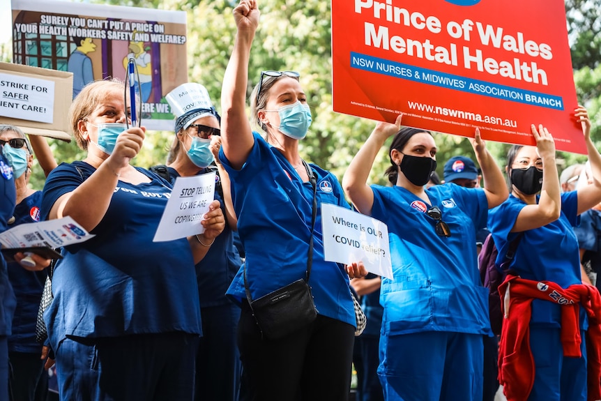 Protesting nurses holding signs