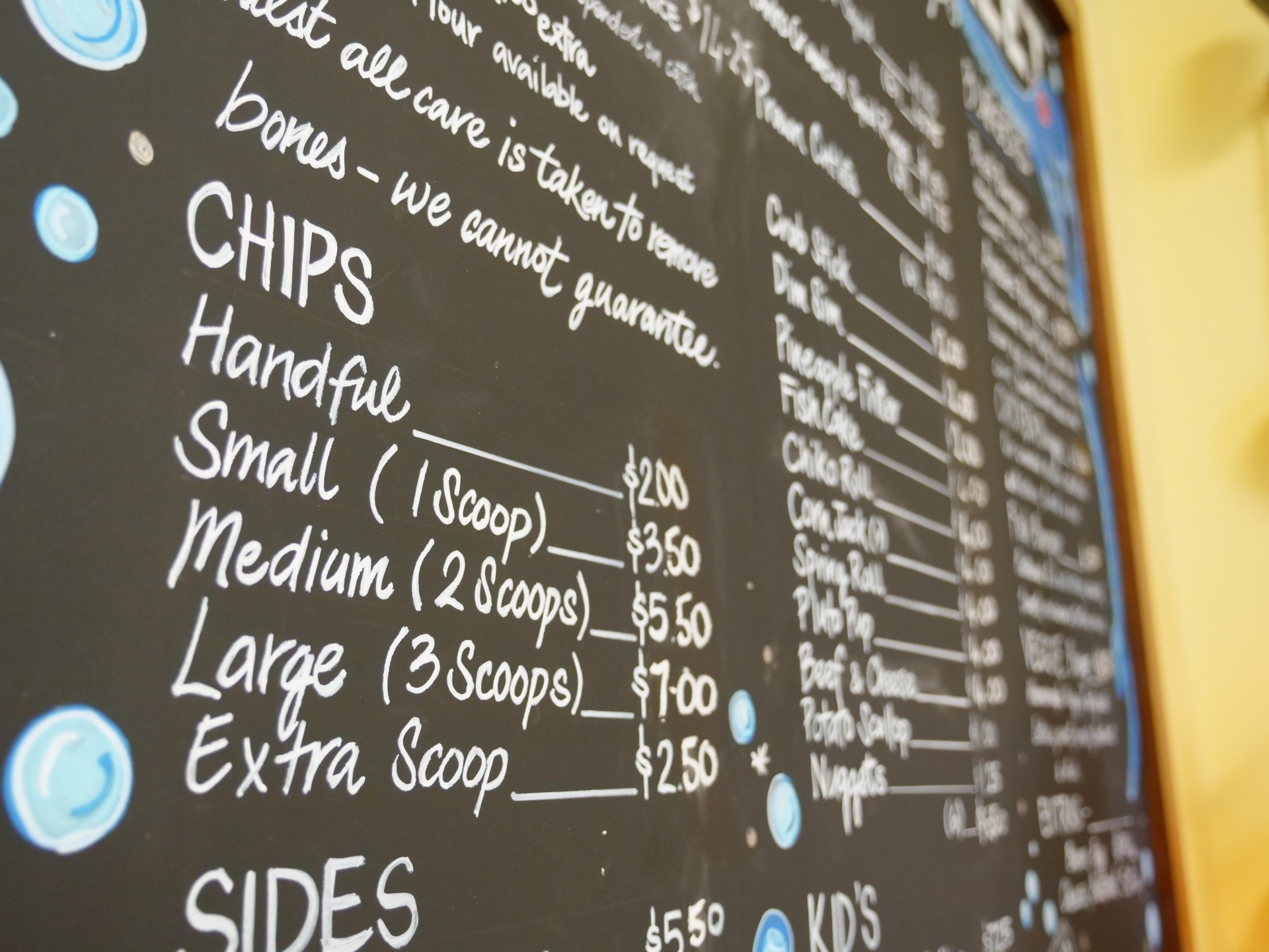 A fish and chip menu board