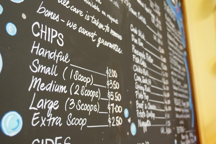 A chalk menu board at a fish and chip shop