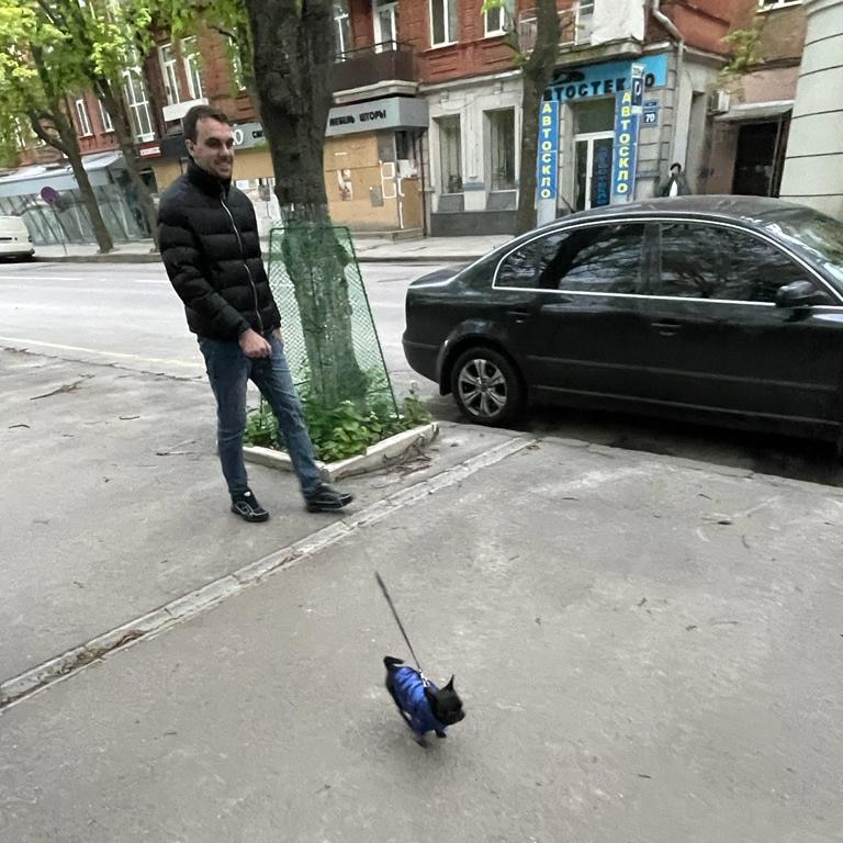 A man walks his Chihuahua through the empty streets of Kharkiv.