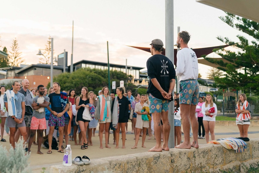 A crowd of people gathering on a foreshore