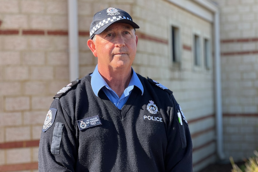 A mid-shot of WA Police Senior Sergeant Ian Francis speaking at a media conference outdoors.