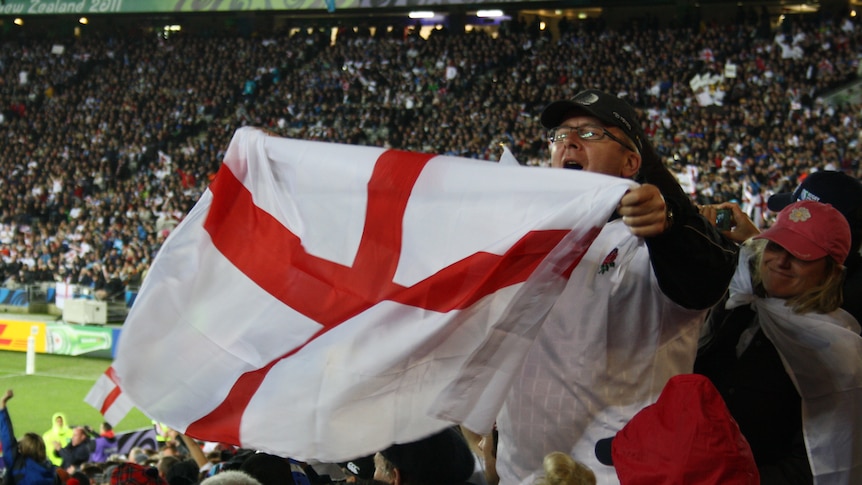 An English supporter waves his flag and sings the national anthem at the Rugby World Cup.