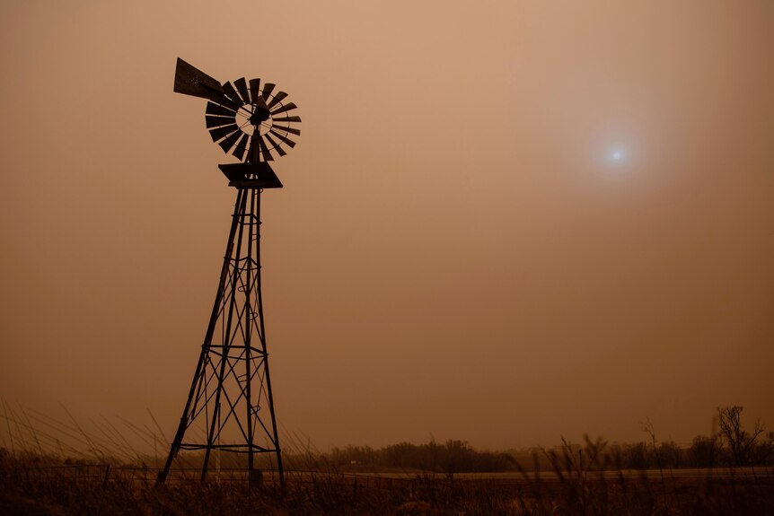 A windmill in a dust storm. 