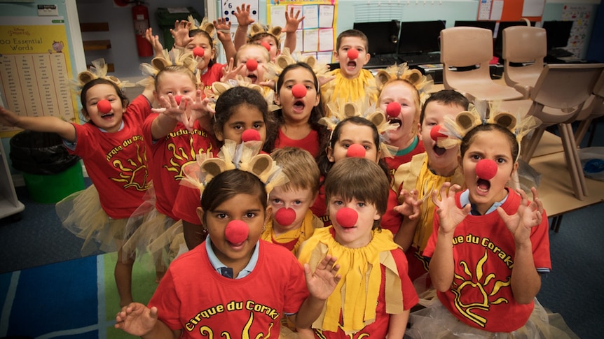 Group of young school children dressed as lions with furry ears, tail and the girls in tulle tutus.