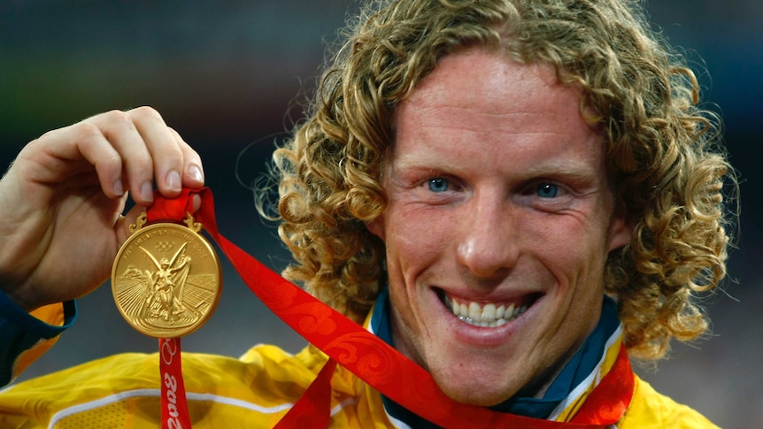 Steve Hooker shows off his gold medal at the 2008 Beijing Olympics.