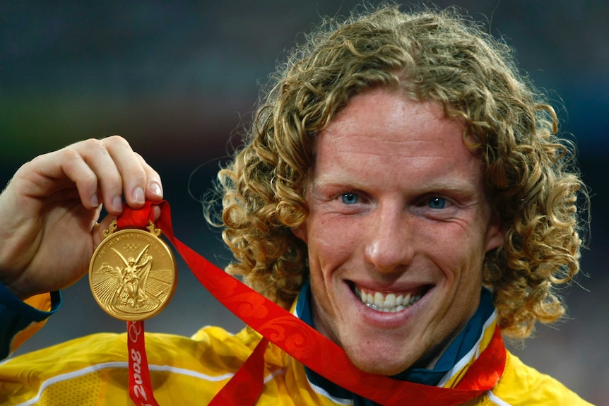 Steve Hooker shows off his gold medal at the 2008 Beijing Olympics.