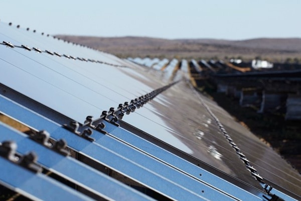 A close-up side-on shot of solar panels at a solar farm.