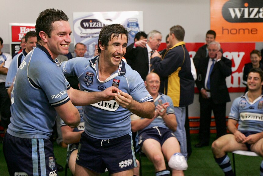 Danny Buderus and Andrew Johns celebrate in the NSW Blues locker room after winning the 2005 State of Origin decider.