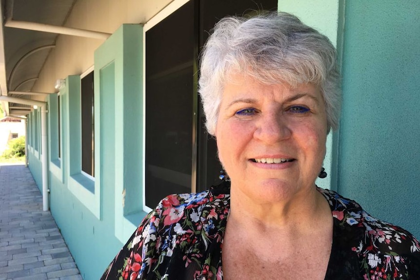 An older woman with short grey hair, smiling.