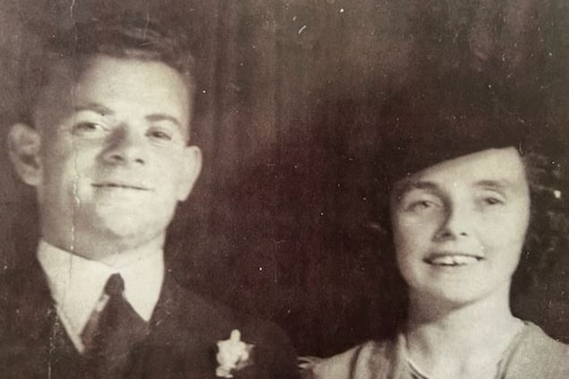 A black and white photo of a smiling man and woman.