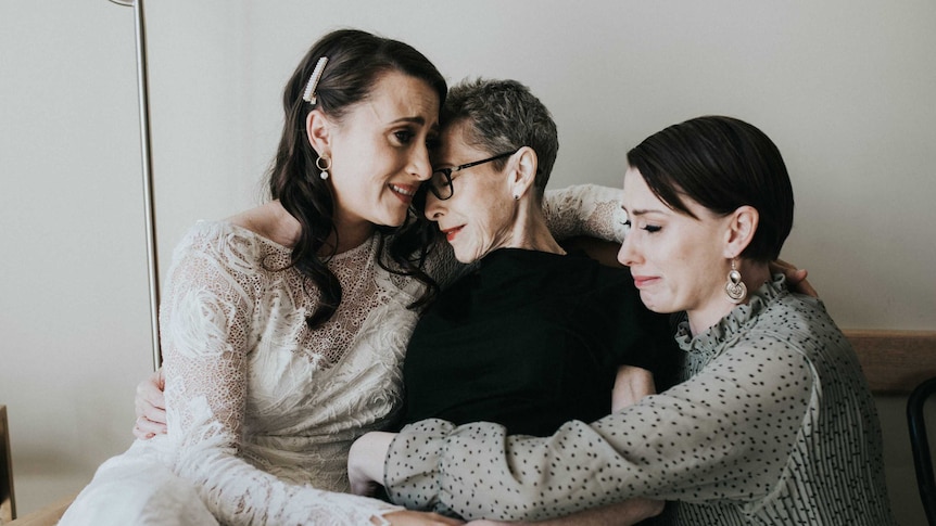 Three women hugging.