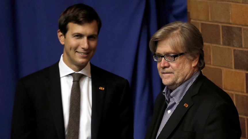 Jared Kushner (left) and Stephen Bannon stand off-stage during a Trump rally