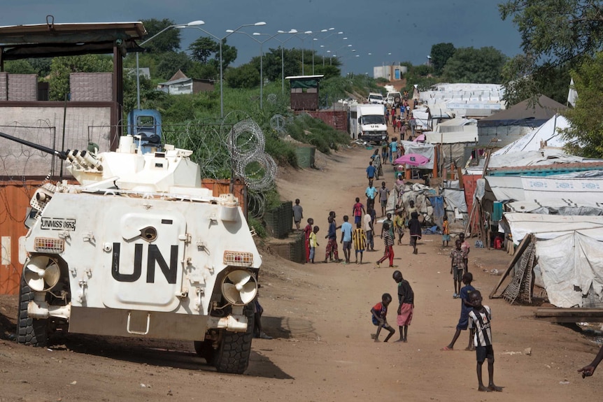 A UN armoured personnel carrier is seen parked inside a camp for internally-displaced people.