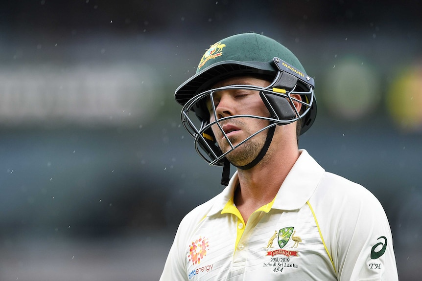 Cricketer Travis Head looks exasperated, leaning his head back slightly with closed eyes.