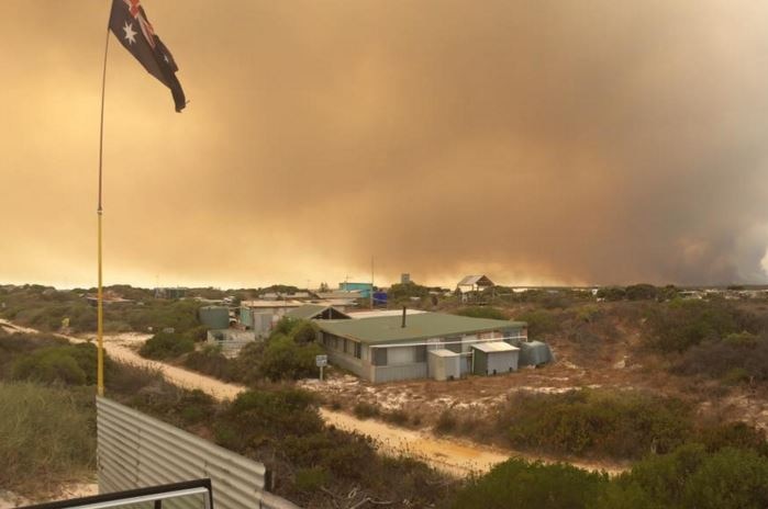 Smoke looms on the horizon as a blaze bears down on the coastal holiday communities of Wedge Island and Grey.