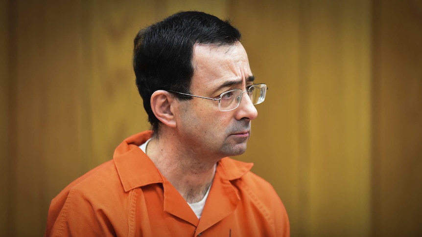 Larry Nassar stands in a Michigan court to be sentenced for sexual assault in February 2018.